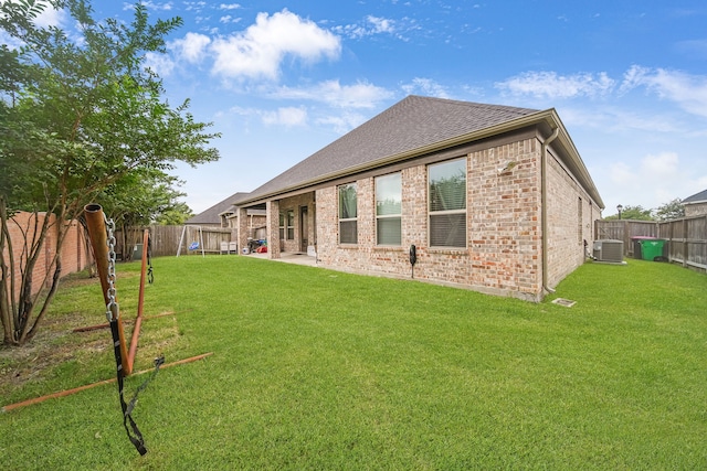 18610 Fairmont Springs Ct, Cypress, TX 77429 - rear view of house featuring cooling unit, brick siding, and a shingled roof