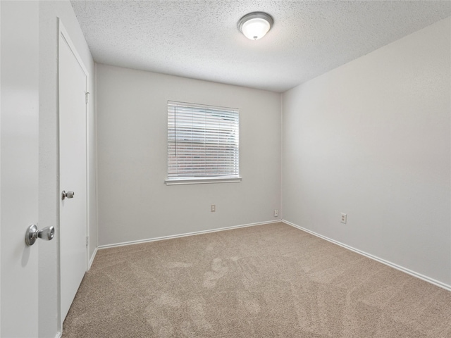 2431 Muddy Peak Dr, San Antonio, TX 78245 - carpeted empty room featuring a textured ceiling and baseboards