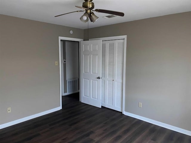 9305 Gardner St, Beaumont, TX 77707 - unfurnished bedroom featuring baseboards, dark wood-type flooring, a closet, and a ceiling fan