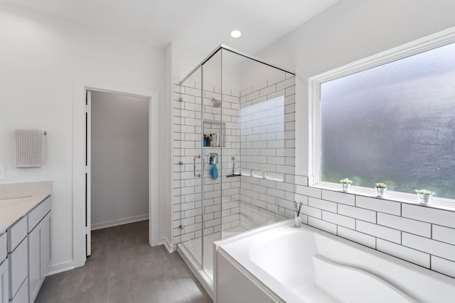 14027 Valley Creek Ct, Conroe, TX 77384 - bathroom featuring a shower stall, a garden tub, vanity, recessed lighting, and baseboards