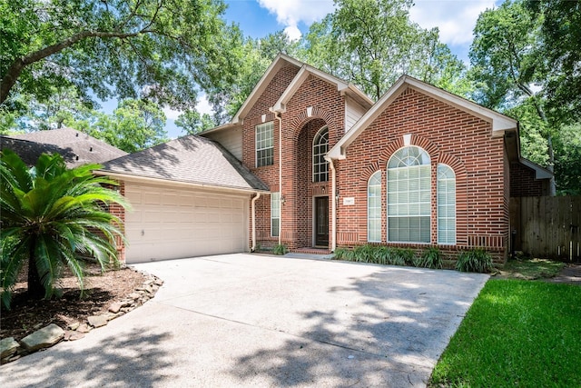 8907 Opus Ct, Houston, TX 77040 - traditional home featuring brick siding, a garage, driveway, and roof with shingles