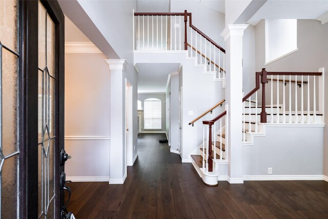 8907 Opus Ct, Houston, TX 77040 - foyer featuring decorative columns, wood finished floors, baseboards, stairway, and crown molding