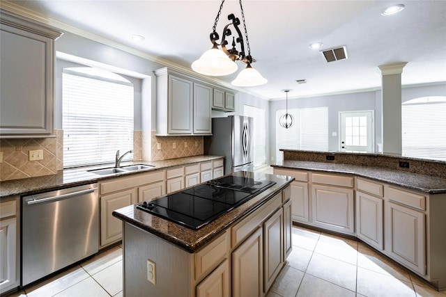 8907 Opus Ct, Houston, TX 77040 - kitchen featuring stainless steel appliances, a sink, a kitchen island, crown molding, and light tile patterned floors