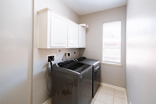 8907 Opus Ct, Houston, TX 77040 - laundry area featuring cabinet space, washer and clothes dryer, baseboards, and plenty of natural light