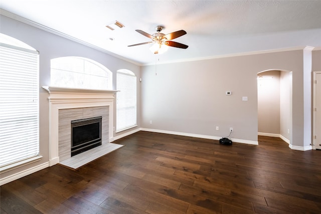 8907 Opus Ct, Houston, TX 77040 - unfurnished living room with a ceiling fan, arched walkways, dark wood-style floors, baseboards, and a fireplace