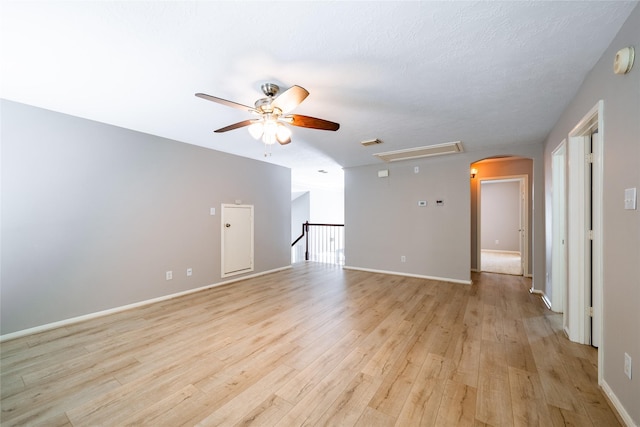 8907 Opus Ct, Houston, TX 77040 - unfurnished room featuring ceiling fan, light wood-style floors, arched walkways, baseboards, and a smoke detector