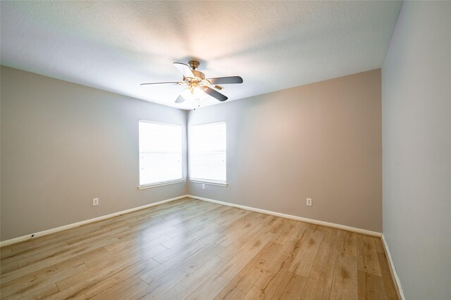 8907 Opus Ct, Houston, TX 77040 - empty room featuring ceiling fan, baseboards, light wood-style flooring, and a textured ceiling