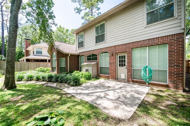 8907 Opus Ct, Houston, TX 77040 - back of house with a patio and brick siding