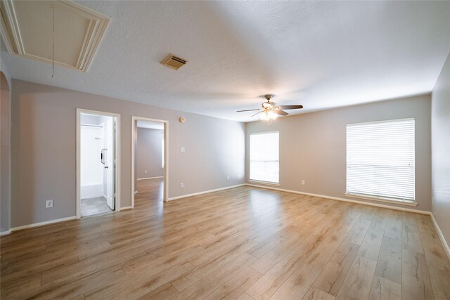 8907 Opus Ct, Houston, TX 77040 - empty room with attic access, ceiling fan, baseboards, and light wood-style flooring