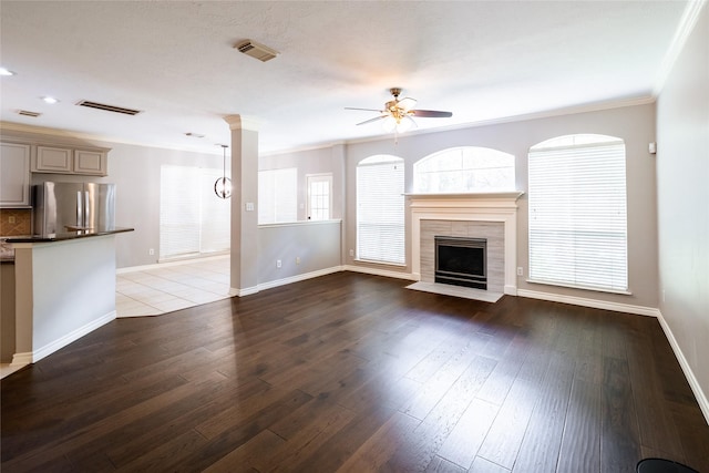 8907 Opus Ct, Houston, TX 77040 - unfurnished living room with ceiling fan, crown molding, a fireplace, baseboards, and dark wood-style floors