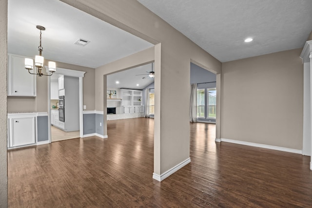 4322 Shady Springs Dr, Pasadena, TX 77586 - kitchen featuring open floor plan, ceiling fan, wood finished floors, white cabinets, and a chandelier