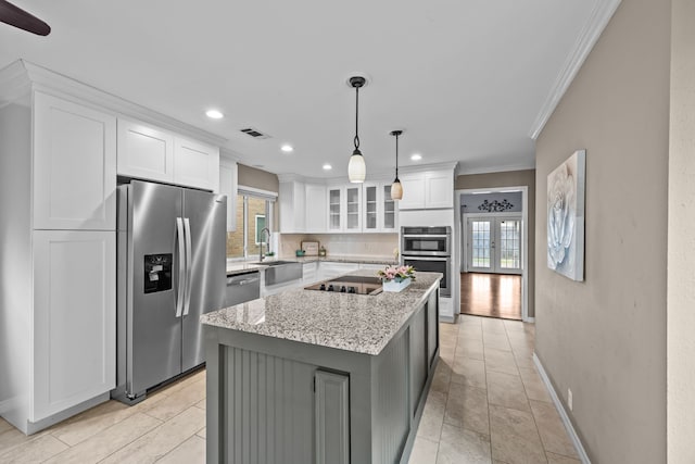 4322 Shady Springs Dr, Pasadena, TX 77586 - kitchen with stainless steel appliances, ornamental molding, healthy amount of natural light, backsplash, and white cabinetry