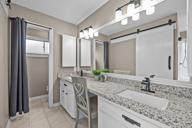 4322 Shady Springs Dr, Pasadena, TX 77586 - full bathroom with double vanity, toilet, marble look tile flooring, and baseboards