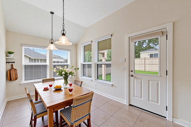 3635 Sunlight Hill Ln, Spring, TX 77386 - dining room with lofted ceiling, light tile patterned flooring, and baseboards