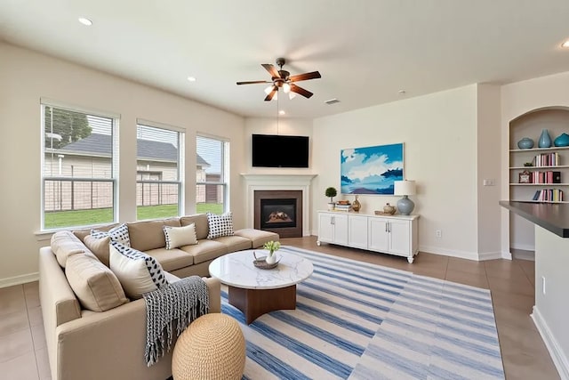 3635 Sunlight Hill Ln, Spring, TX 77386 - living area featuring a ceiling fan, baseboards, tile patterned floors, a glass covered fireplace, and recessed lighting