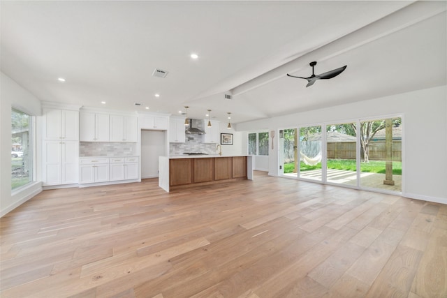 2618 Pine Village Dr, Houston, TX 77080 - unfurnished living room featuring light wood-type flooring, healthy amount of natural light, ceiling fan, and recessed lighting