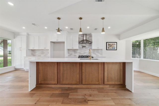2618 Pine Village Dr, Houston, TX 77080 - kitchen featuring wall chimney exhaust hood, a sink, light countertops, decorative backsplash, and recessed lighting
