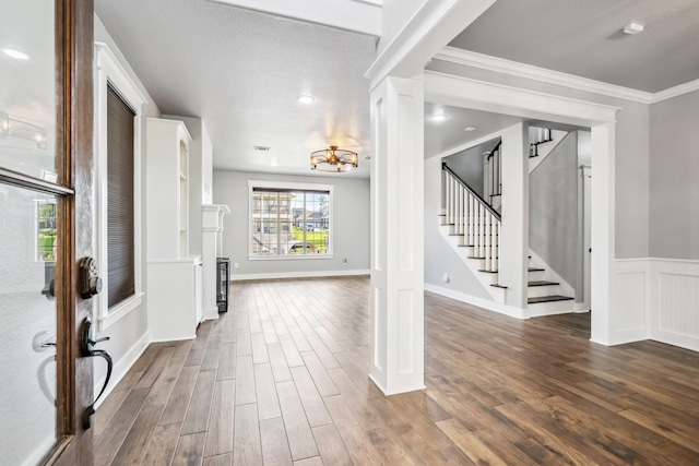 12336 Pebble View Dr, Conroe, TX 77304 - foyer entrance featuring dark wood-type flooring, stairs, a chandelier, ornate columns, and crown molding
