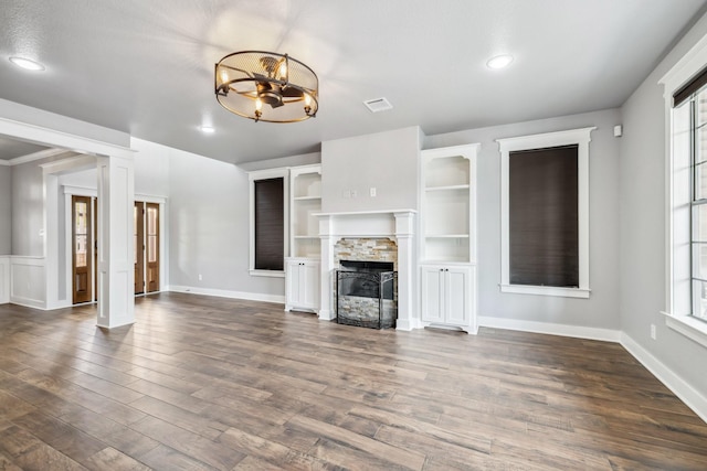 12336 Pebble View Dr, Conroe, TX 77304 - unfurnished living room with a fireplace, dark wood-style floors, a chandelier, baseboards, and recessed lighting