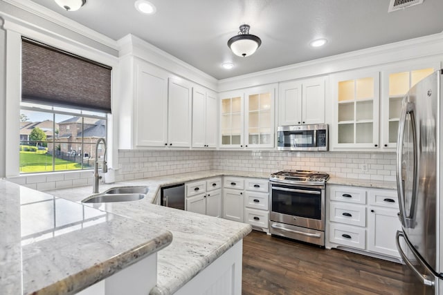 12336 Pebble View Dr, Conroe, TX 77304 - kitchen with appliances with stainless steel finishes, white cabinets, recessed lighting, and crown molding