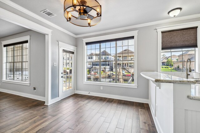 12336 Pebble View Dr, Conroe, TX 77304 - unfurnished dining area with dark wood-style flooring, a chandelier, baseboards, and ornamental molding