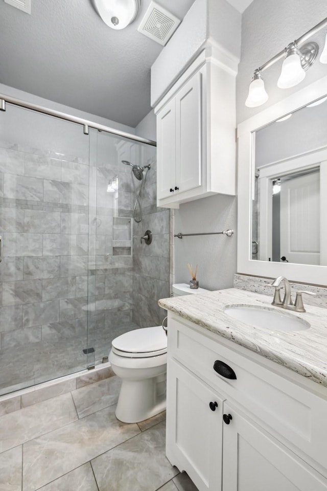 12336 Pebble View Dr, Conroe, TX 77304 - full bathroom featuring vanity, a stall shower, and toilet