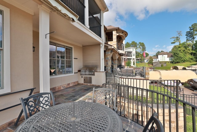 12336 Pebble View Dr, Conroe, TX 77304 - view of patio with outdoor dining space, a balcony, and a residential view