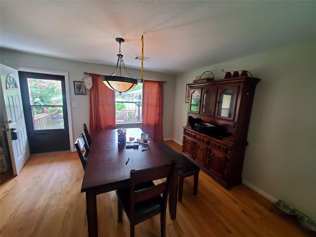 24027 Spears Cir, New Caney, TX 77357 - dining room featuring healthy amount of natural light, light wood-style floors, and baseboards