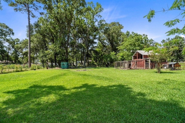 24027 Spears Cir, New Caney, TX 77357 - view of grassy yard featuring an outbuilding
