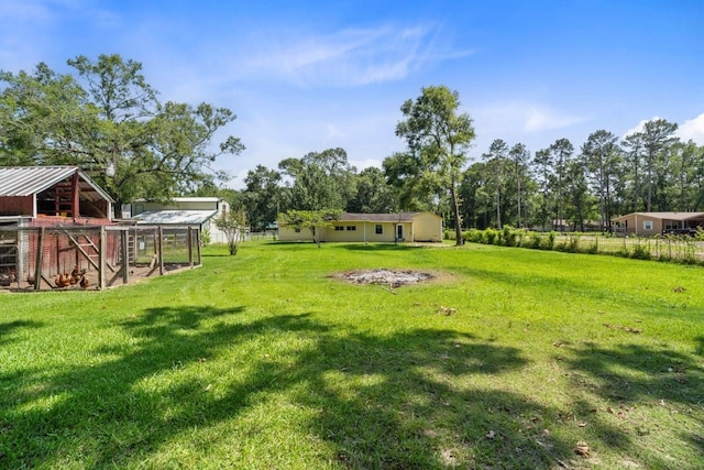 24027 Spears Cir, New Caney, TX 77357 - view of grassy yard with exterior structure and an outdoor structure