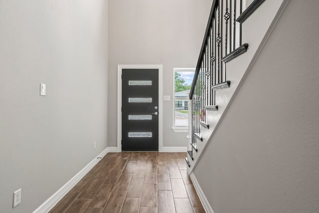 15608 Navajo Trl, Willis, TX 77378 - foyer featuring stairs, dark wood finished floors, and baseboards