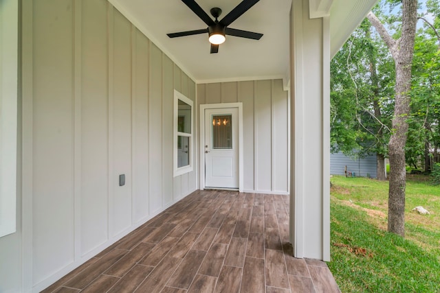 15608 Navajo Trl, Willis, TX 77378 - doorway to property featuring board and batten siding, a ceiling fan, and a yard