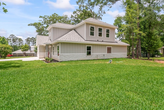 15608 Navajo Trl, Willis, TX 77378 - view of front of house with a shingled roof, stone siding, driveway, and a front lawn