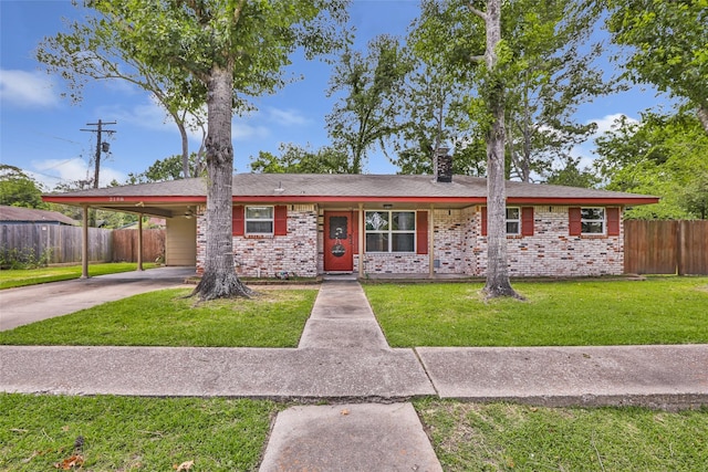 2198 N Winfree St, Dayton, TX 77535 - ranch-style house with brick siding, driveway, an attached carport, and a chimney