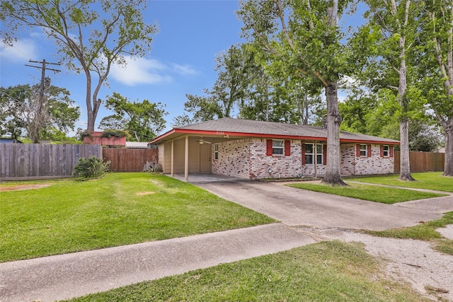 2198 N Winfree St, Dayton, TX 77535 - single story home with concrete driveway, an attached carport, and brick siding