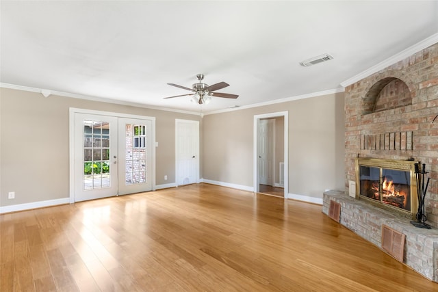 2198 N Winfree St, Dayton, TX 77535 - unfurnished living room with baseboards, a brick fireplace, ceiling fan, wood finished floors, and french doors