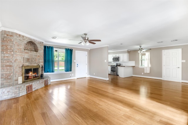2198 N Winfree St, Dayton, TX 77535 - unfurnished living room with ceiling fan, plenty of natural light, light wood-style floors, and crown molding