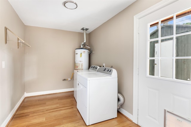 2198 N Winfree St, Dayton, TX 77535 - washroom with gas water heater, washing machine and dryer, light wood-style floors, and baseboards