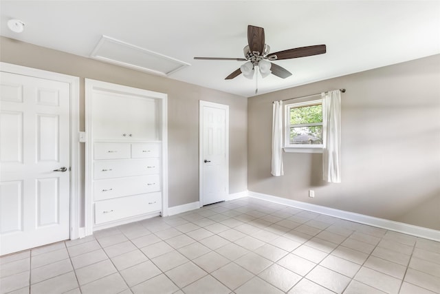 2198 N Winfree St, Dayton, TX 77535 - unfurnished bedroom featuring attic access, light tile patterned floors, baseboards, and a ceiling fan