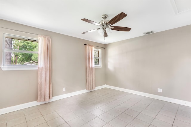 2198 N Winfree St, Dayton, TX 77535 - empty room featuring a ceiling fan, plenty of natural light, baseboards, and light tile patterned floors