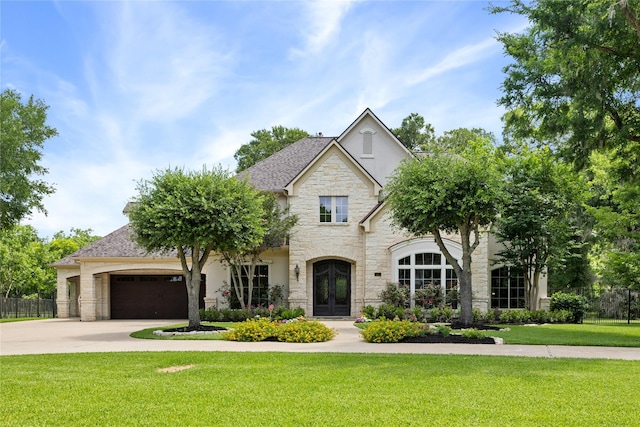 11 Bees Creek Ct, Missouri City, TX 77459 - view of front of property featuring french doors, stone siding, a garage, concrete driveway, and roof with shingles