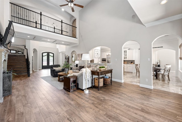 11 Bees Creek Ct, Missouri City, TX 77459 - living area featuring a ceiling fan, high vaulted ceiling, wood finished floors, stairway, and baseboards