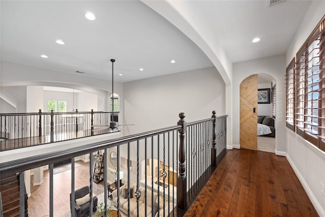 11 Bees Creek Ct, Missouri City, TX 77459 - hall with healthy amount of natural light, recessed lighting, wood finished floors, baseboards, and arched walkways