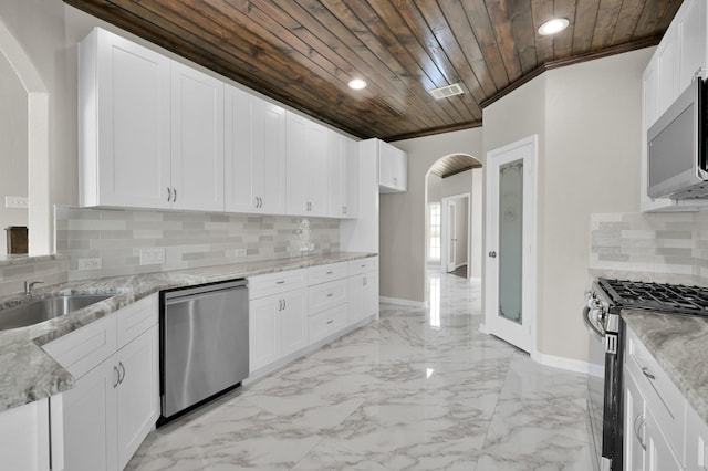 30507 Woodson Trace Dr, Spring, TX 77386 - kitchen featuring stainless steel appliances, wood ceiling, arched walkways, recessed lighting, and a sink