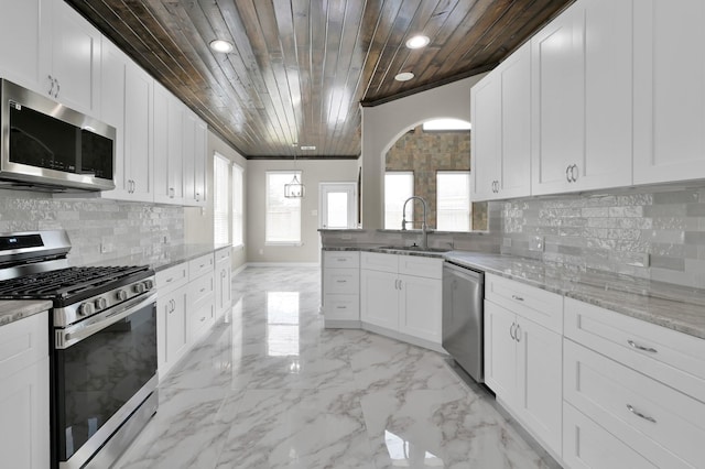 30507 Woodson Trace Dr, Spring, TX 77386 - kitchen featuring appliances with stainless steel finishes, a sink, wood ceiling, recessed lighting, and white cabinetry