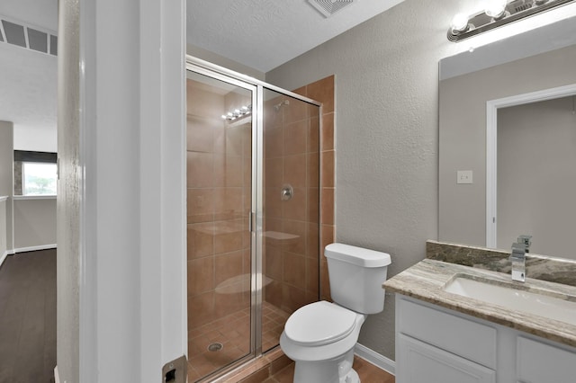 30507 Woodson Trace Dr, Spring, TX 77386 - bathroom featuring vanity, a textured wall, toilet, a stall shower, and wood finished floors