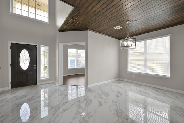 30507 Woodson Trace Dr, Spring, TX 77386 - entrance foyer with light marble finish flooring, a chandelier, wood ceiling, and baseboards
