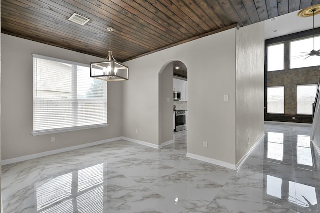 30507 Woodson Trace Dr, Spring, TX 77386 - spare room featuring arched walkways, wooden ceiling, baseboards, light marble finish flooring, and a chandelier