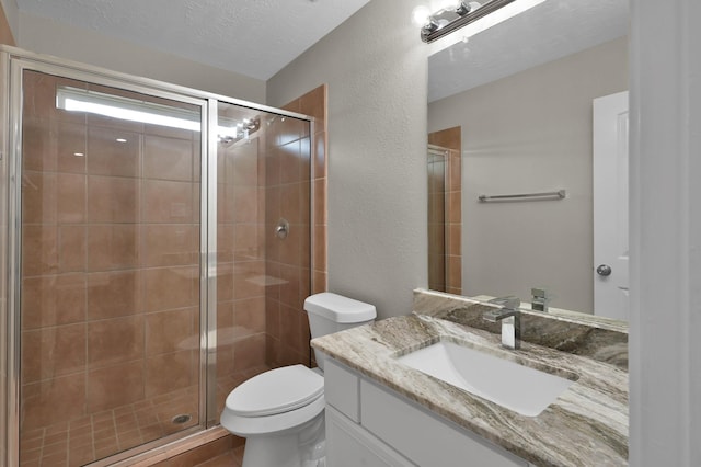 30507 Woodson Trace Dr, Spring, TX 77386 - full bath featuring vanity, a stall shower, toilet, a textured wall, and a textured ceiling