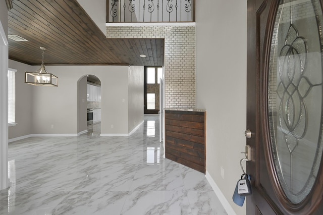 30507 Woodson Trace Dr, Spring, TX 77386 - entryway with arched walkways, baseboards, marble tiled flooring, wooden ceiling, and a chandelier